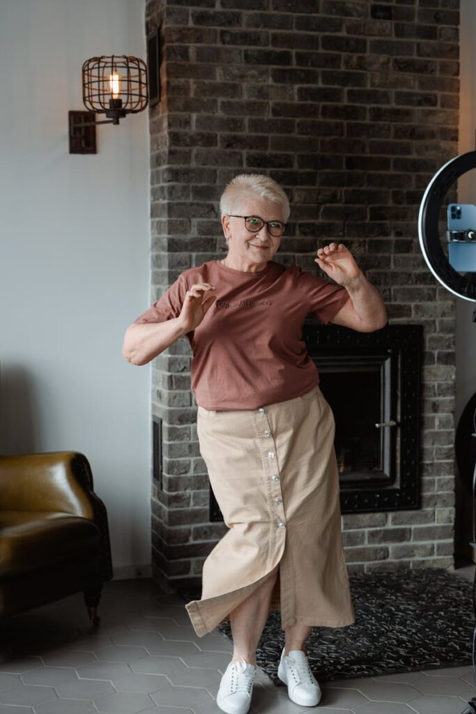 A cheerful senior woman dancing in a cozy living room, embracing the joy of movement.